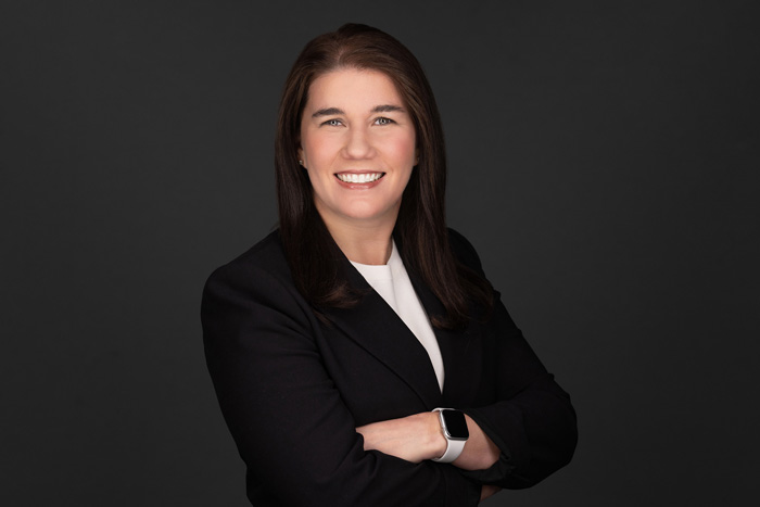 Portrait photo of Lila Snyder smiling on grey background