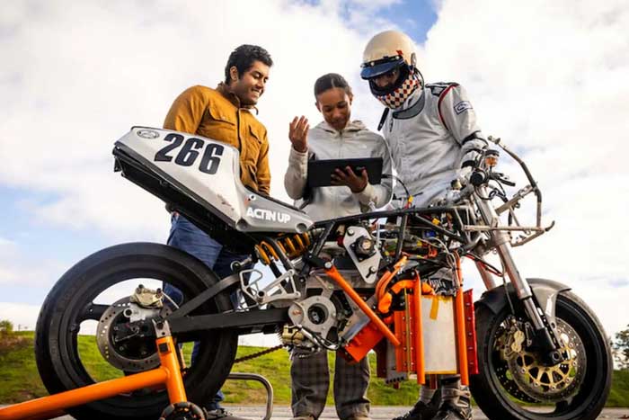 Anand John, Rachel Mohammed, and Aditya Mehrotra monitor their bike’s performance,